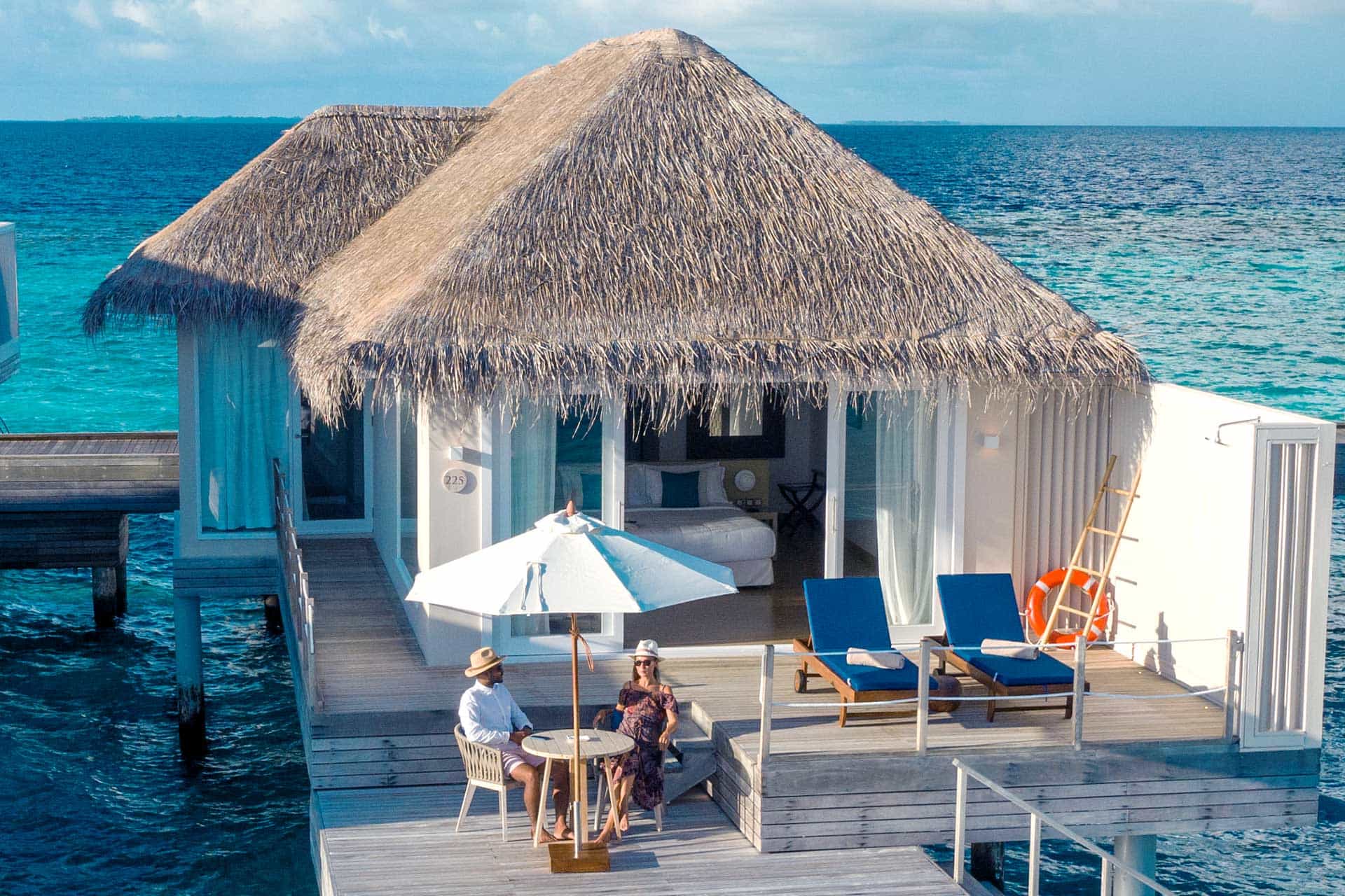 Aerial view of overwater bungalows at Baglioni Resort Maldives stretching over brilliant turquoise lagoon